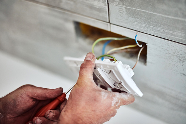 Electrician installing plug