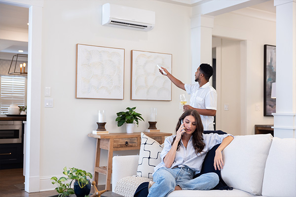 Couple in living room with wine and unit